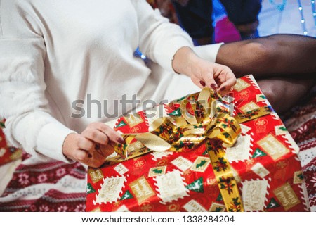The girl opens a gift in a big box