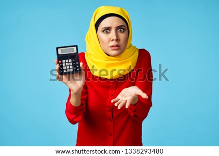   arab woman with finance calculator                            