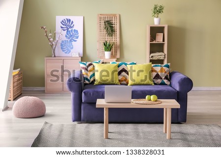 Interior of modern room with comfortable sofa and table