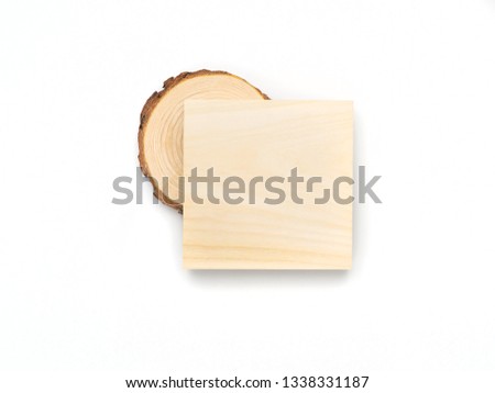 Pine tree cross-section and wooden square on white background. Lumber piece close-up, top view.
