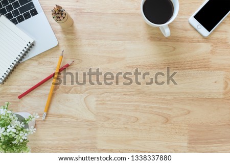 Flay lay, Top view office table desk with smartphone, keyboard, coffee, pencil, notebook with copy space background.
