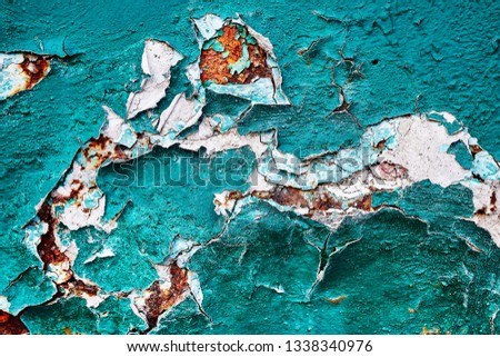 Background texture relief structure age-related changes in metal corrosion chipping cracks rust pieces peeling erosion peeling green paint with white wall surface inserts large fragment. Royalty-Free Stock Photo #1338340976