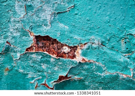 Background relief structure of metal corrosion and cracked rust peeling green paint from a wall surface close-up. Royalty-Free Stock Photo #1338341051
