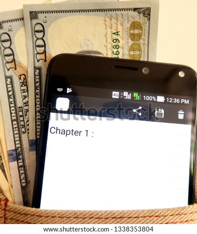 Cash in dollars and Smartphone with a CHAPTER 1 on the screen, concept of make money from Ebook writing and publishing