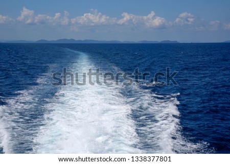 waves of water behind high speed catamaran on Thailand Gulf
