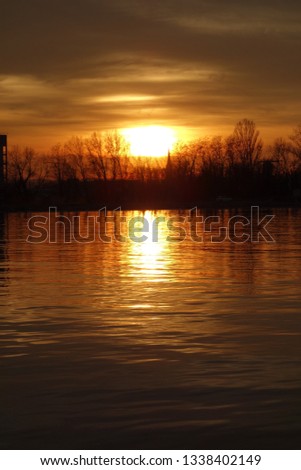 sunset over calm flowing river