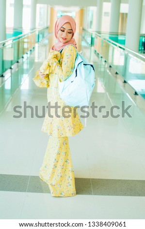 smiling female muslim university student