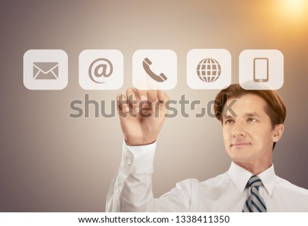 Businessman pressing phone button