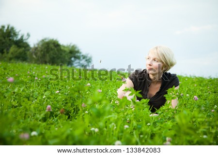 Girl in a field of flowers smiling