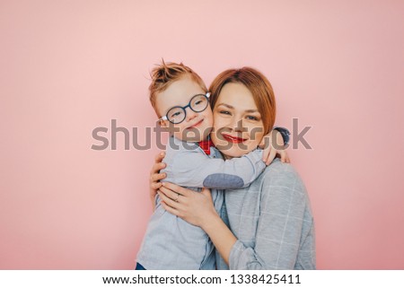 Tender feelings between mom and 
son with Down syndrome Royalty-Free Stock Photo #1338425411
