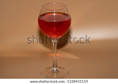 One glass of rose wine on a light background
