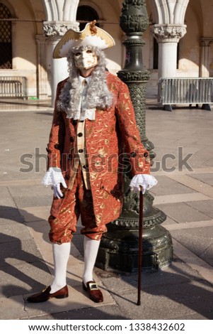 A man posing for the camera at the Carnival of Venice. Royalty-Free Stock Photo #1338432602
