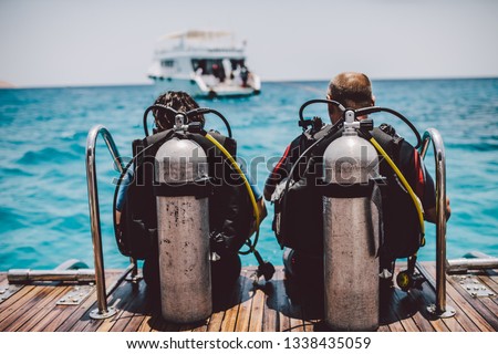 Diving lesson in open water. Scuba diver before diving into ocean. Royalty-Free Stock Photo #1338435059