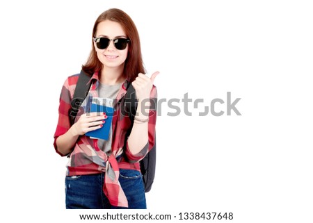 Female hiker walking and looking at a cell phone isolated on white background. Hiking. Girl hiker with backpack, passport and plane tickets.