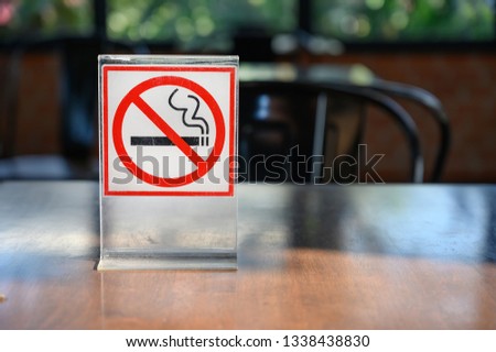 No smoking sign on wooden table in coffee shop Don't smoking place in public