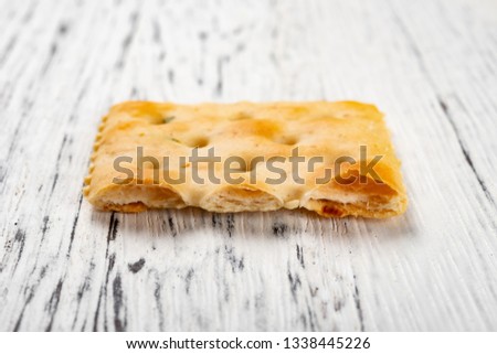 cross section of crispy cracker on white wood background