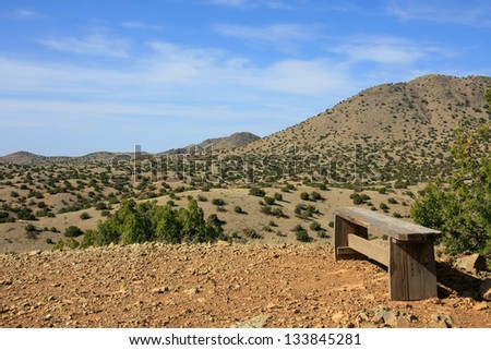 A wooden bench on a summit in Cerillos Hills State Park Royalty-Free Stock Photo #133845281