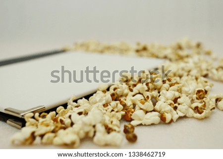 Book and popcorn on white