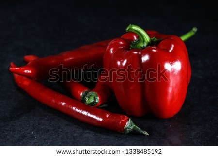 paprika and red hot pepper on a black background