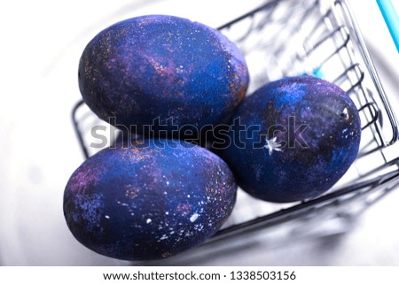 Eastern space-dyed eggs in shopping cart Royalty-Free Stock Photo #1338503156