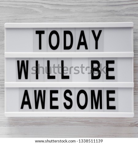 'Today will be awesome' words on lightbox over white wooden surface, top view. Overhead, flat lay, from above. 