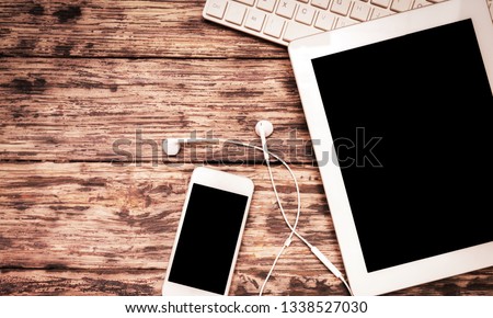 Smartphone with blank screen and table pc on  background