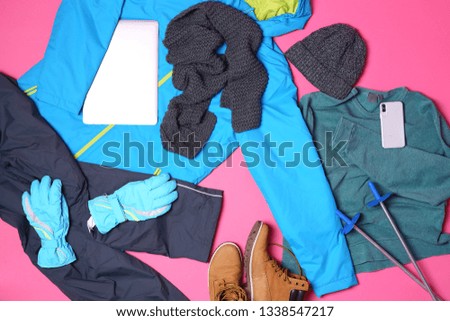 Set of warm sports clothes and devices on color background, flat lay. Winter vacation