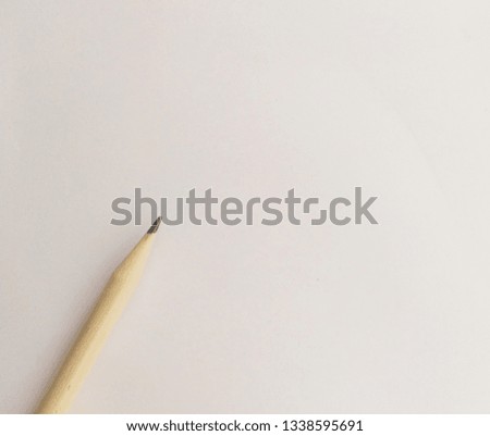  Close up of wooden pencil on white paper or isolate.