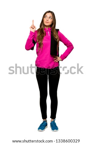 Full-length shot of Young sport woman with fingers crossing and wishing the best over isolated white background