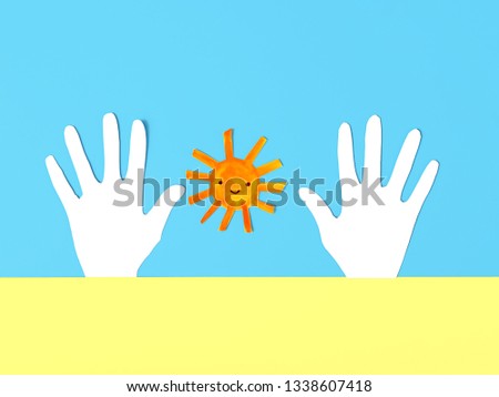 paper cute sun and hands on blue-yellow background. World down syndrome day concept. copy space