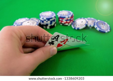 aces in poker hand with chips. 