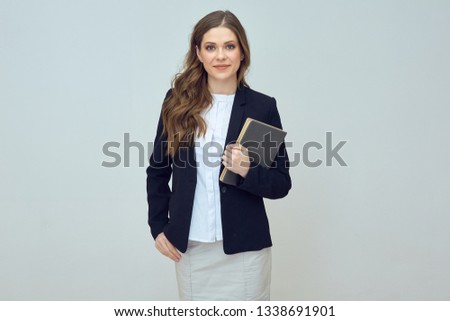 smiling woman teacher holding book. isolated studio portrait.