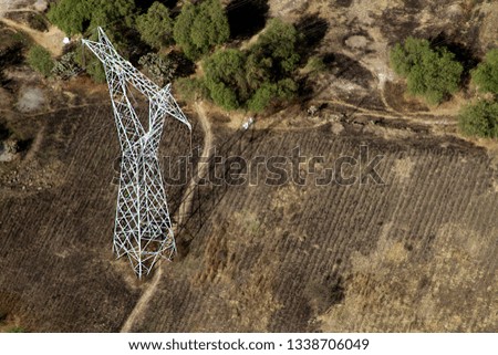 Aerial view of high voltage metal post or tower at the countryside