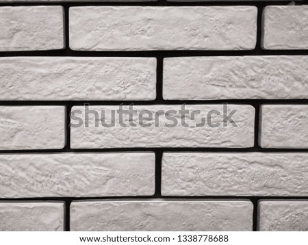 Gray wall of textured bricks. Empty grey brick wall background with concrete and rough aged structure. Neat brickwork for building. Grunge bricks wallpaper 