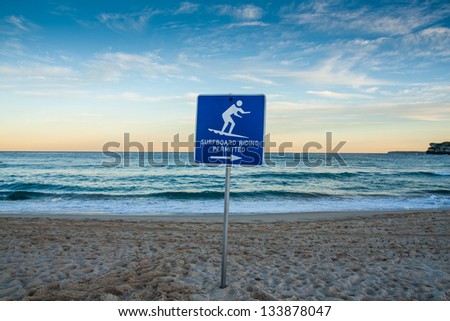 Sunset beach with surf sign.