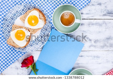 Flowers, Two cups of aromatic coffee and heart-shaped toasts for a romantic morning of lovers. Red rose, letter or note on the table. The concept of Valentine's Day and Mother's Day. Flat lay. Cjpy
