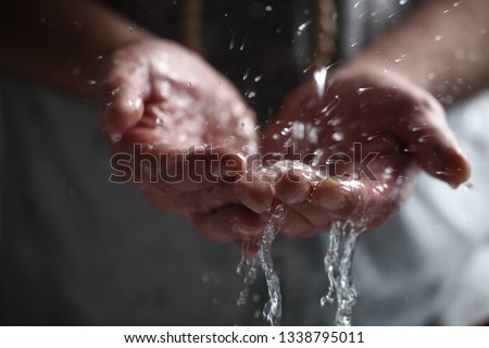 Muslim man washes his hands before prayer ritual cleansing. Royalty-Free Stock Photo #1338795011