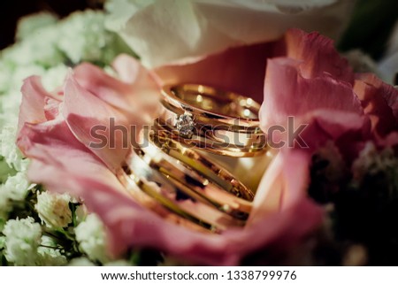 Wedding rings close-up lie on the wedding bouquet of flowers.