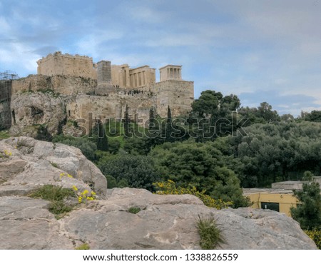 Background view of Ancient Acropolis with green landscape in Athens, Greece.