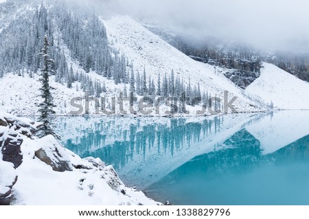 First snow Morning at Moraine Lake in Banff National Park Alberta Canada Snow-covered winter mountain lake in a winter atmosphere. Beautiful background photo concept