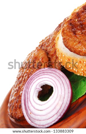 several large hamburger with loaf on wooden plate isolated over white background