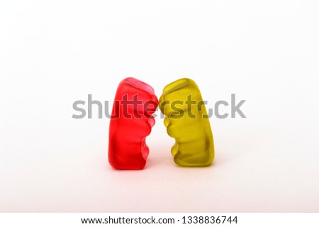 Gummy bears in different colors. Concept babies. Gummy bears are kissing.