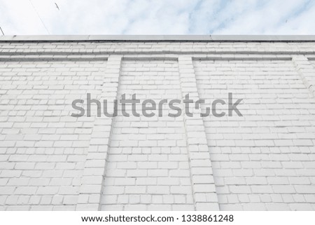 Blank ad space on a white brick wall in the street outside