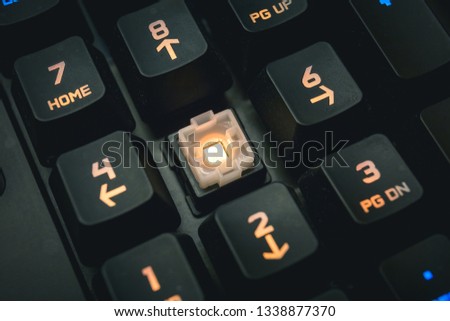 Backlit mechanical keyboard numerical buttons detail shot.