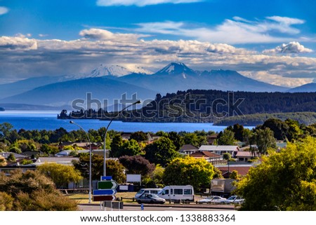 New Zealand, North Island. Taupo town and Lake Taupo, Mt Ngauruhoe, Mt Tongariro and Mt Ruapehu in the background Royalty-Free Stock Photo #1338883364
