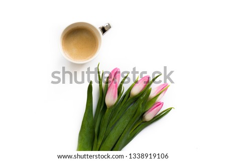 Fresh bouquet of five tulips isolated on white background with a cup of coffee. Spring flowers.