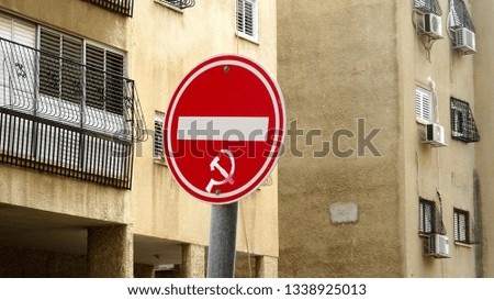 Red road traffic sign "Without entrance" with communist symbols on the street in Israel