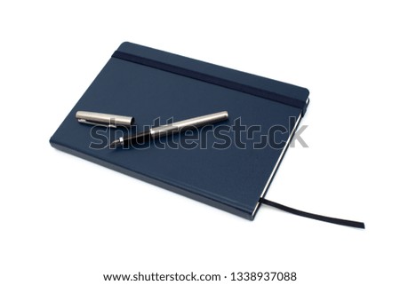 Navy blue notebook with silver fountain pen isolated on white background