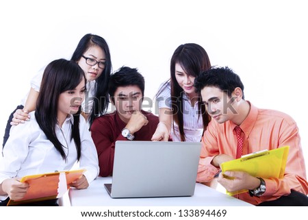 Business team is having a discussion using laptop on white background