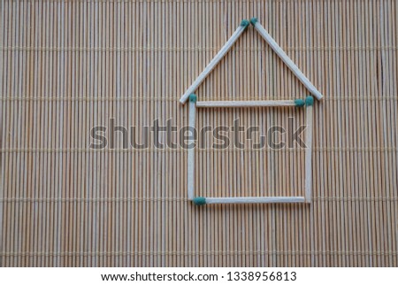 A match house on a table on a light natural background, a hobby at leisure, symbolic fantasy